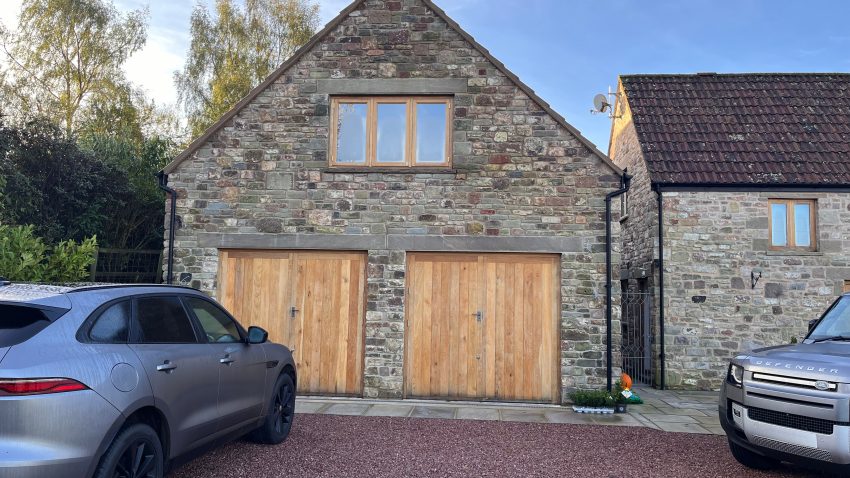 Cars outside new double garage extension designed by Apex Architecture